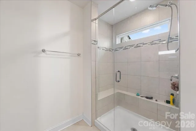a bathroom with a bathtub and shower