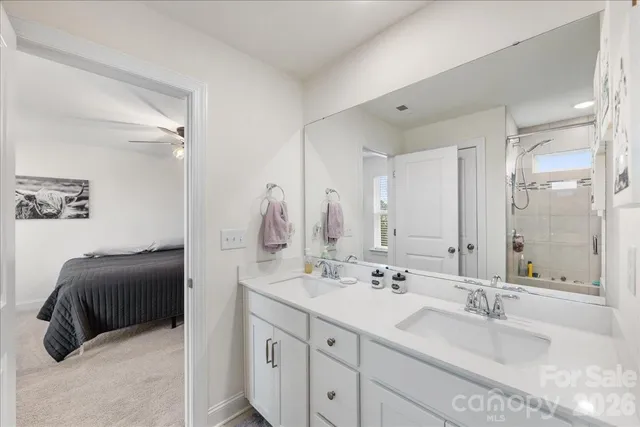 a en suite bathroom with double sink and a mirror