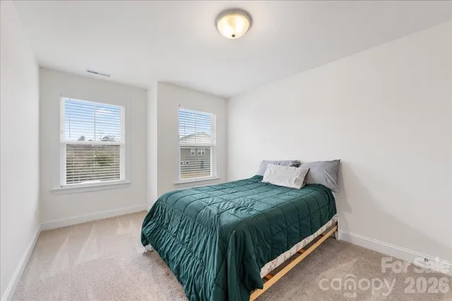 a bedroom with a bed and a lamp