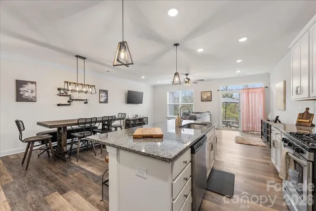 a kitchen with counter space dining table and chairs