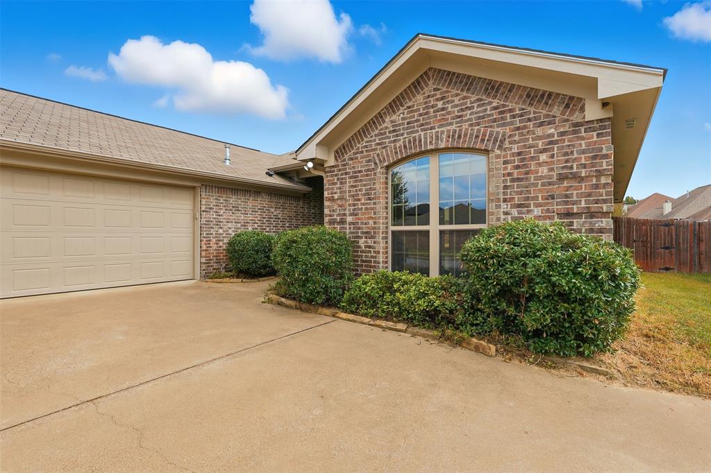2512 Guinn Farms Road Tyler, TX 75707 - Photo 4 of 29 a front view of a house with a yard and garage