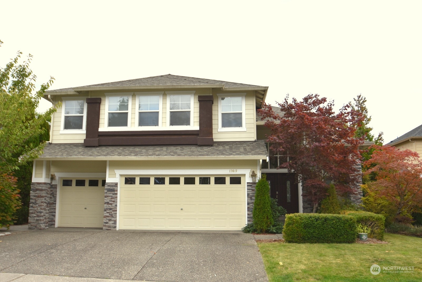 a front view of a house with a garden