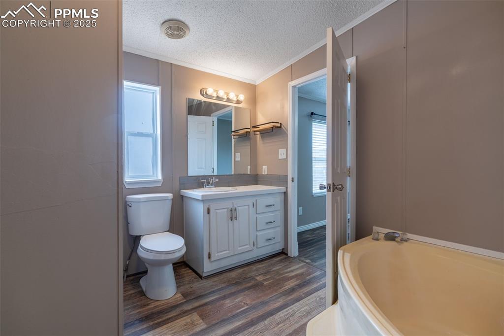 254 Indian Hills Road Florence, CO 81226 - Photo 13 of 22 a bathroom with a granite countertop sink toilet and shower