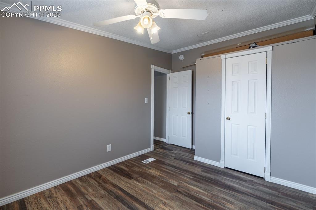 254 Indian Hills Road Florence, CO 81226 - Photo 14 of 22 a view of an empty room with wooden floor