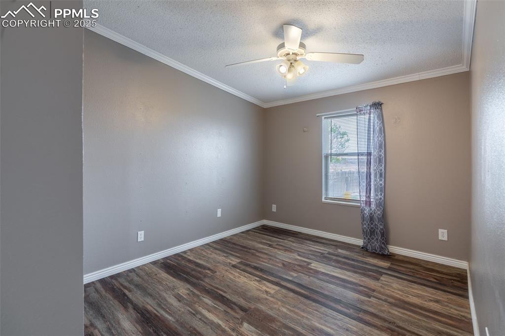254 Indian Hills Road Florence, CO 81226 - Photo 15 of 22 wooden floor in an empty room with a window