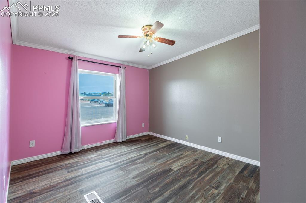 254 Indian Hills Road Florence, CO 81226 - Photo 16 of 22 wooden floor in an empty room with a window