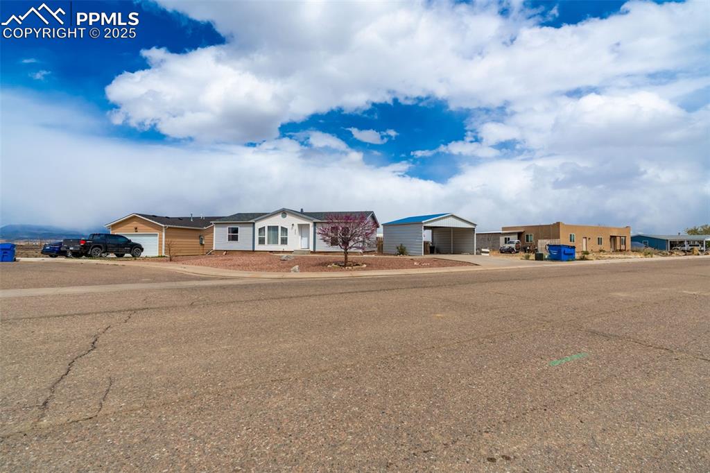 254 Indian Hills Road Florence, CO 81226 - Photo 2 of 22 a front view of a house with a road