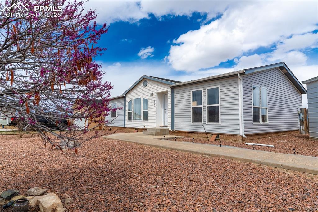 254 Indian Hills Road Florence, CO 81226 - Photo 3 of 22 a front view of a house with a yard