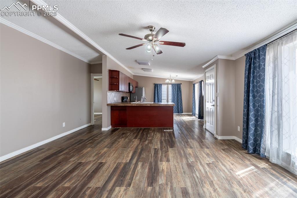 254 Indian Hills Road Florence, CO 81226 - Photo 8 of 22 a big room with wooden floor closet and windows