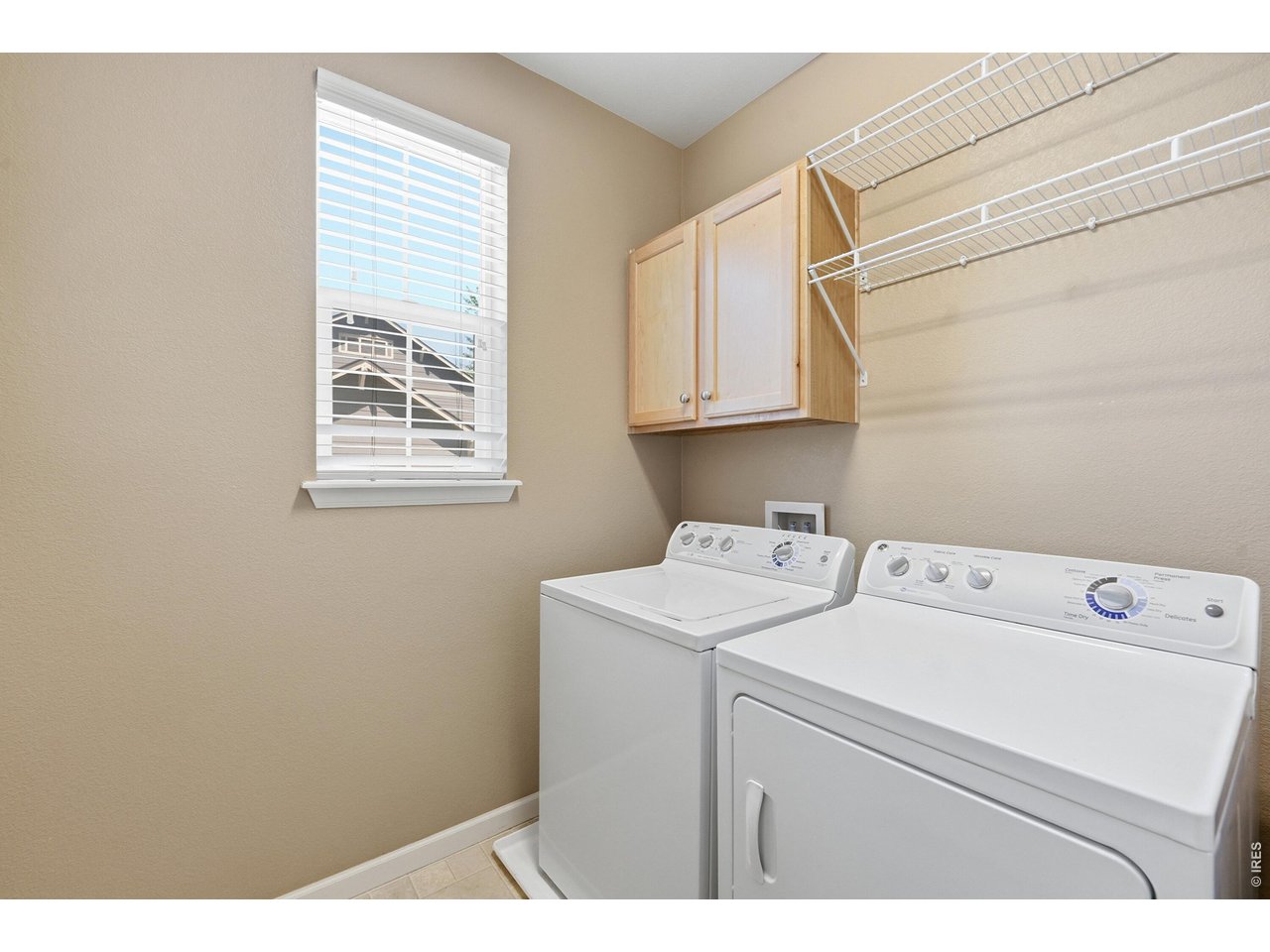 340 Riverton Road Lafayette, CO 80026 - Photo 11 of 37 Main level laundry room with built-in cabinets and shelving