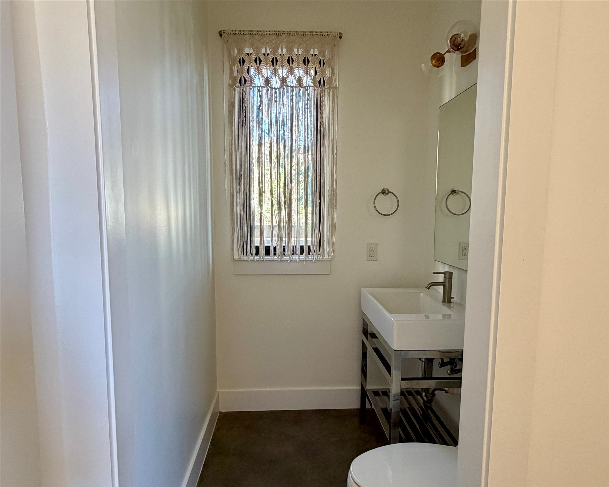 1515 Hether Street, Unit B Austin, TX 78704 - Photo 11 of 30 A well-appointed half bath features a sleek vessel sink and contemporary fixtures, bathed in natural light.