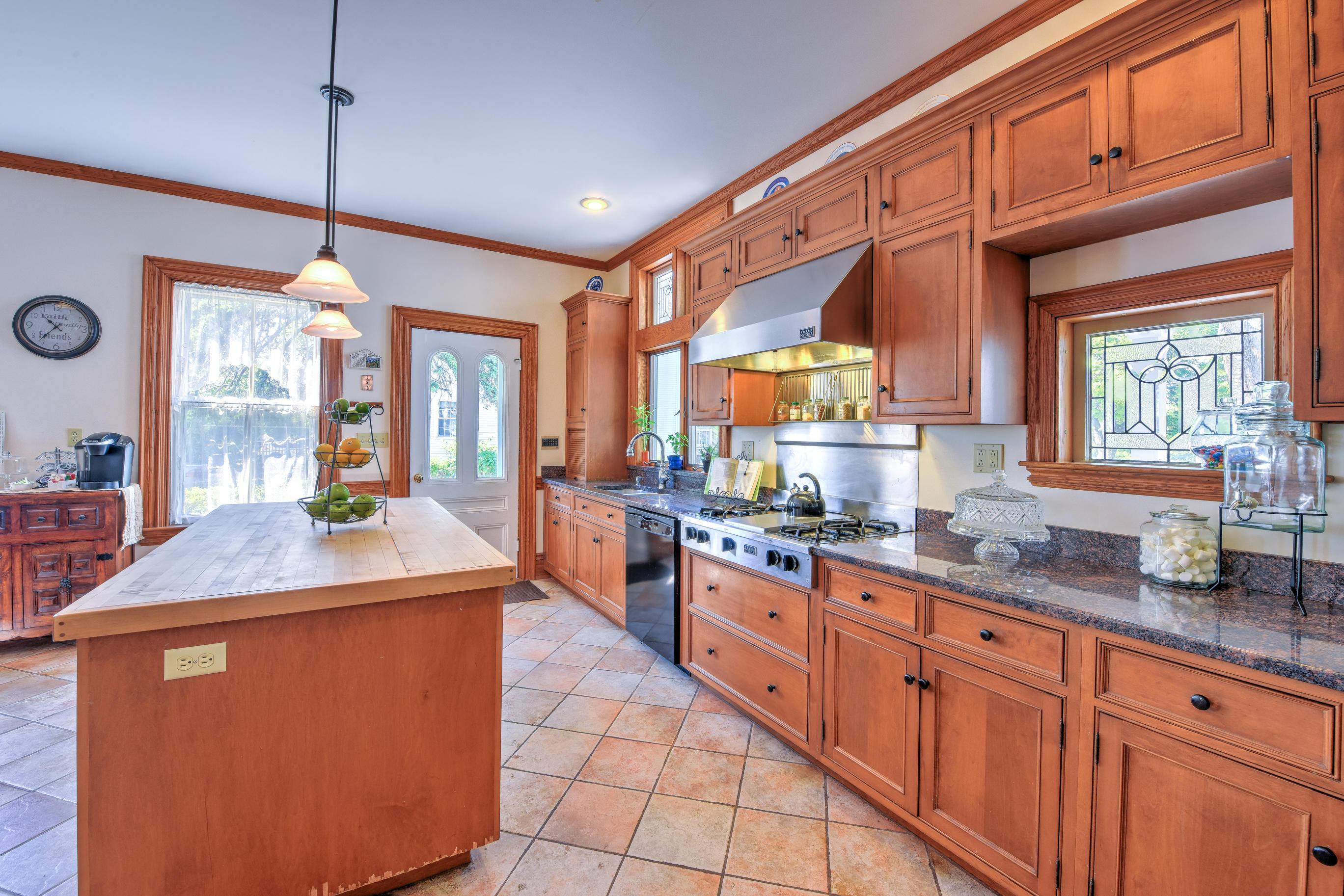 508 Main Street Centerville, MA 02632 - Photo 14 of 35 a kitchen with stainless steel appliances granite countertop a sink a stove a dining table and chairs with wooden floor