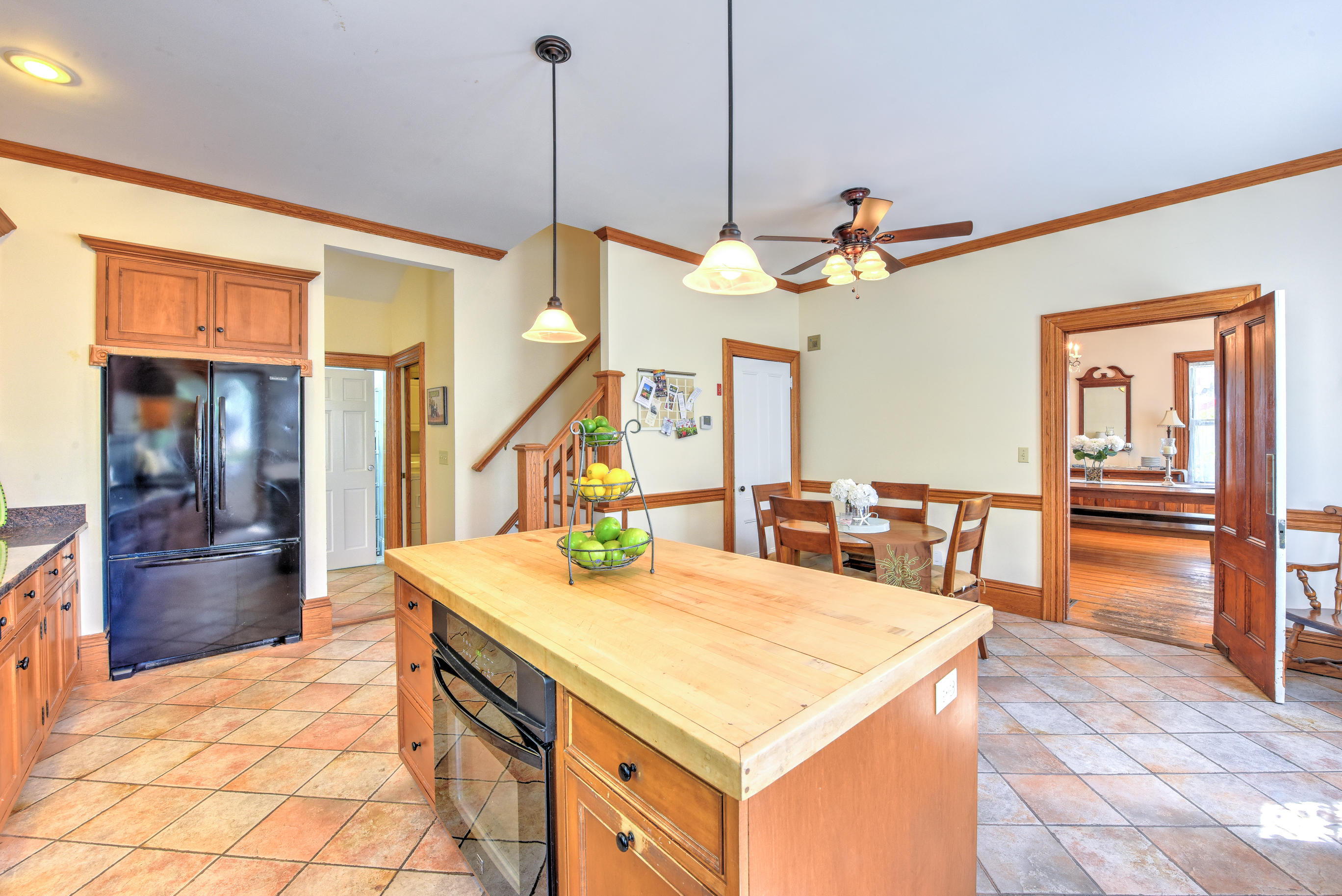 508 Main Street Centerville, MA 02632 - Photo 16 of 35 a kitchen with a stove a refrigerator a sink a dining table and chairs with wooden floor