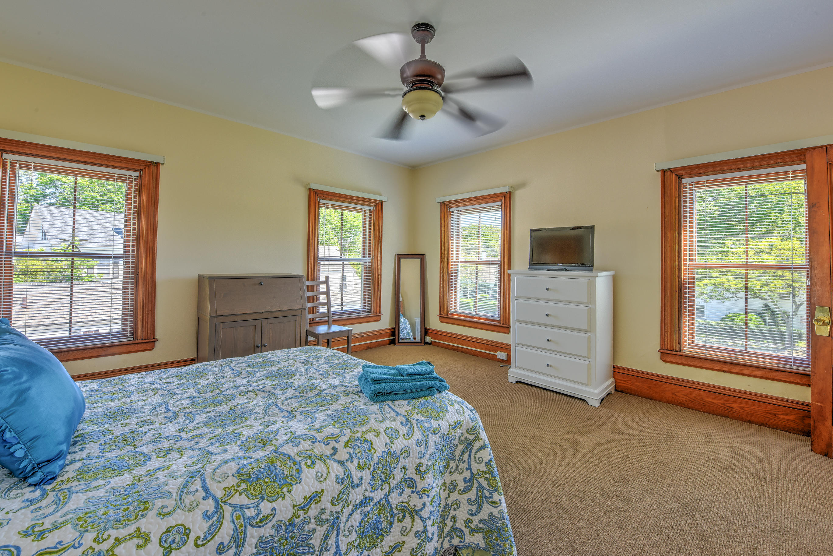 508 Main Street Centerville, MA 02632 - Photo 21 of 35 a bedroom with a bed and a chandelier