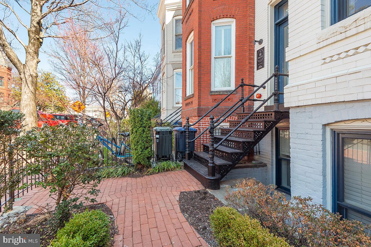 418 7th Street Southeast, Unit 302 Washington, DC 20003 - Photo 3 of 35 a view of a house with brick walls and flower plants