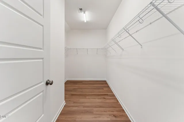 a view of a room with wooden floor