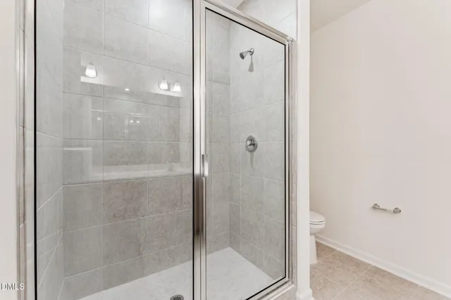 a bathroom with a glass shower door