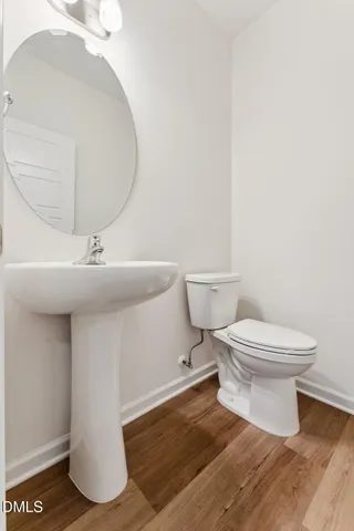 a white toilet sitting next to a white sink