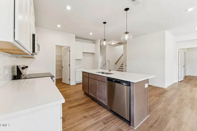 a kitchen with a sink a stove and a refrigerator