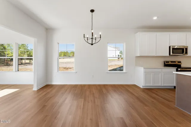 a view of room with window and wooden floor