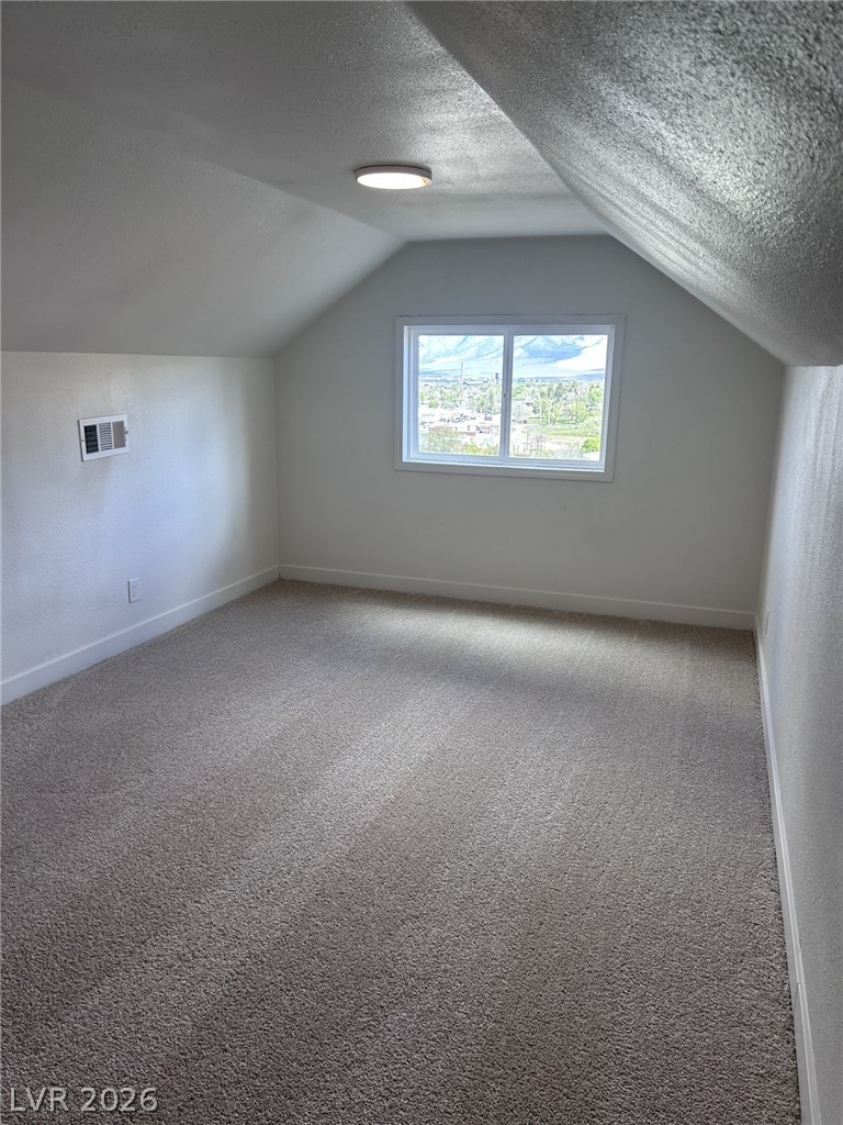 1 Carson Court Ely, NV 89301 - Photo 13 of 20 Up stairs-This cozy room features soft carpeting and a window offering views of the surrounding landscape.