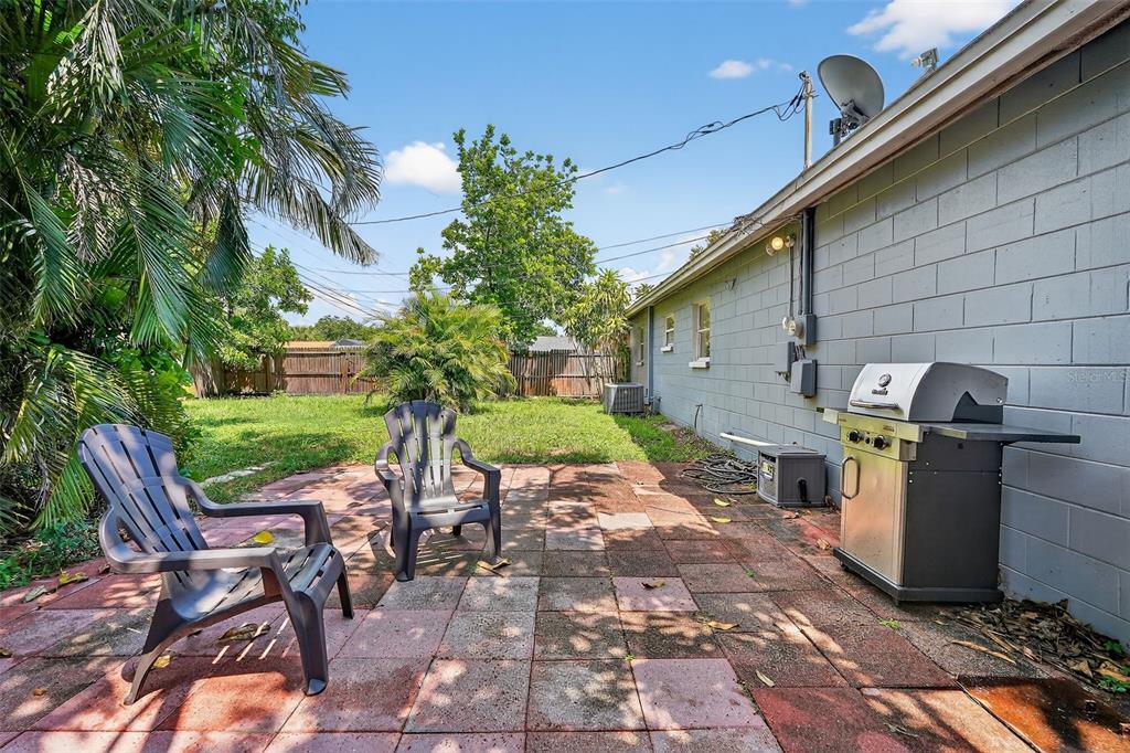 11119 Temple Avenue Seminole, FL 33772 - Photo 24 of 35 a view of a chairs and table in backyard of the house