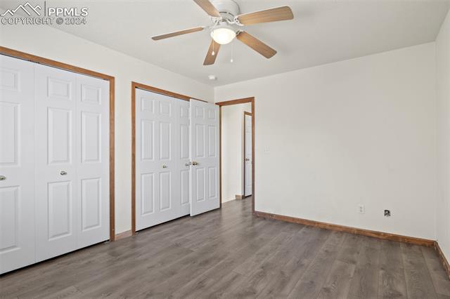 4763 Brant Road Colorado Springs, CO 80911 - Photo 19 of 26 Unfurnished bedroom with light wood-type flooring, two closets, and ceiling fan