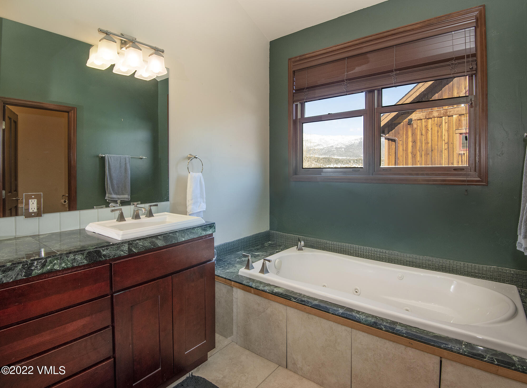 213 Bluffs Drive Eagle, CO 81631 - Photo 13 of 35 a bathroom with a granite countertop sink and a mirror