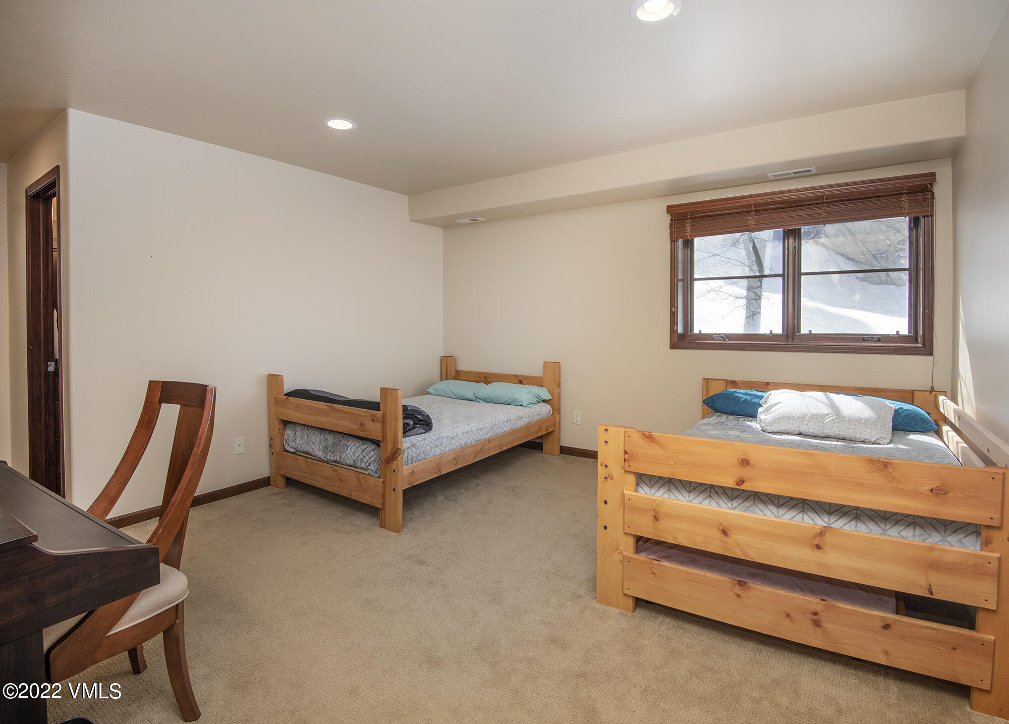 213 Bluffs Drive Eagle, CO 81631 - Photo 20 of 35 a room with a bed and a window