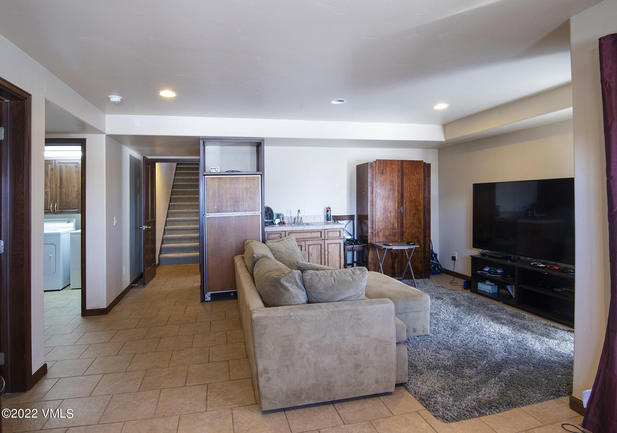 213 Bluffs Drive Eagle, CO 81631 - Photo 24 of 35 a living room with furniture and a flat screen tv