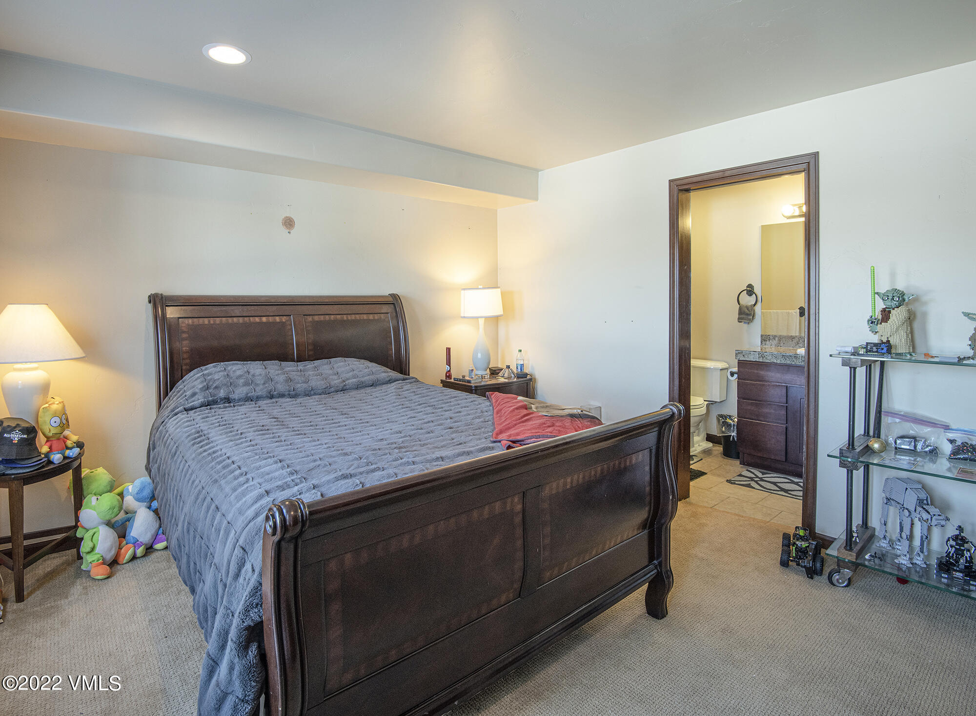 213 Bluffs Drive Eagle, CO 81631 - Photo 26 of 35 a bed sitting in a room next to a lamp