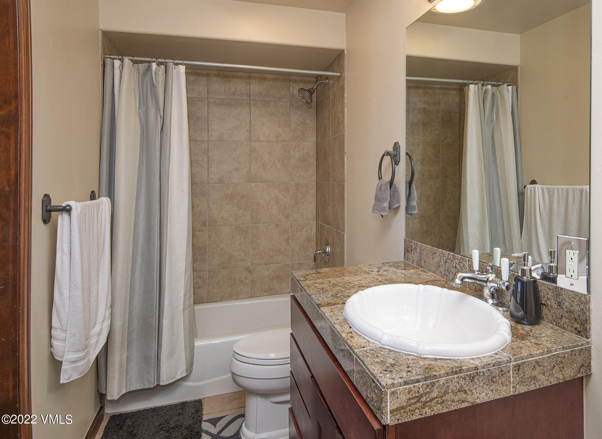 213 Bluffs Drive Eagle, CO 81631 - Photo 27 of 35 a bathroom with a granite countertop sink a toilet and shower