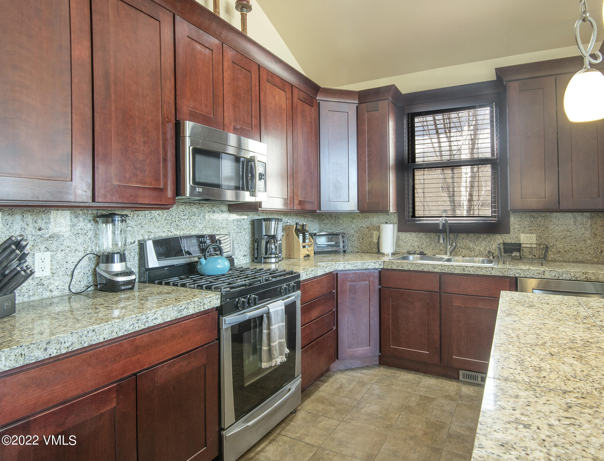 213 Bluffs Drive Eagle, CO 81631 - Photo 10 of 35 a kitchen with stainless steel appliances granite countertop a stove sink and cabinets