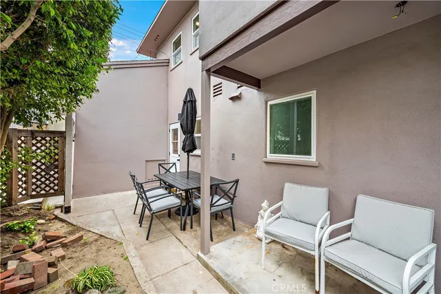 a view of a patio with table and chairs and potted plants