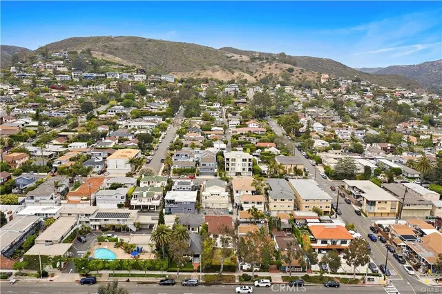 an aerial view of residential houses with city view