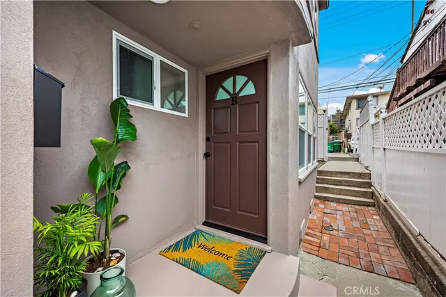 a view of an entryway with wooden floor and a potted plant