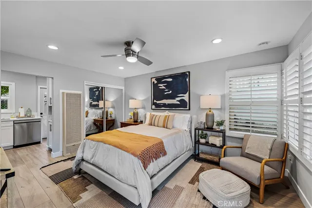 a bedroom with a bed a couch and dresser