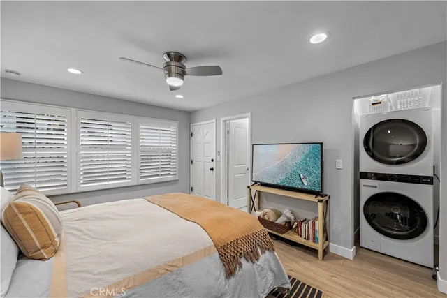 a bedroom with a washing machine and a chair