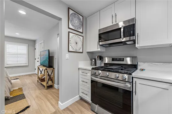a kitchen with stainless steel appliances a stove a microwave and cabinets