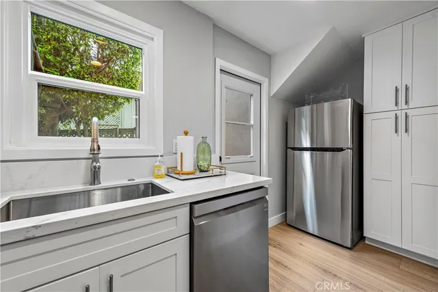 a kitchen with a refrigerator and a sink