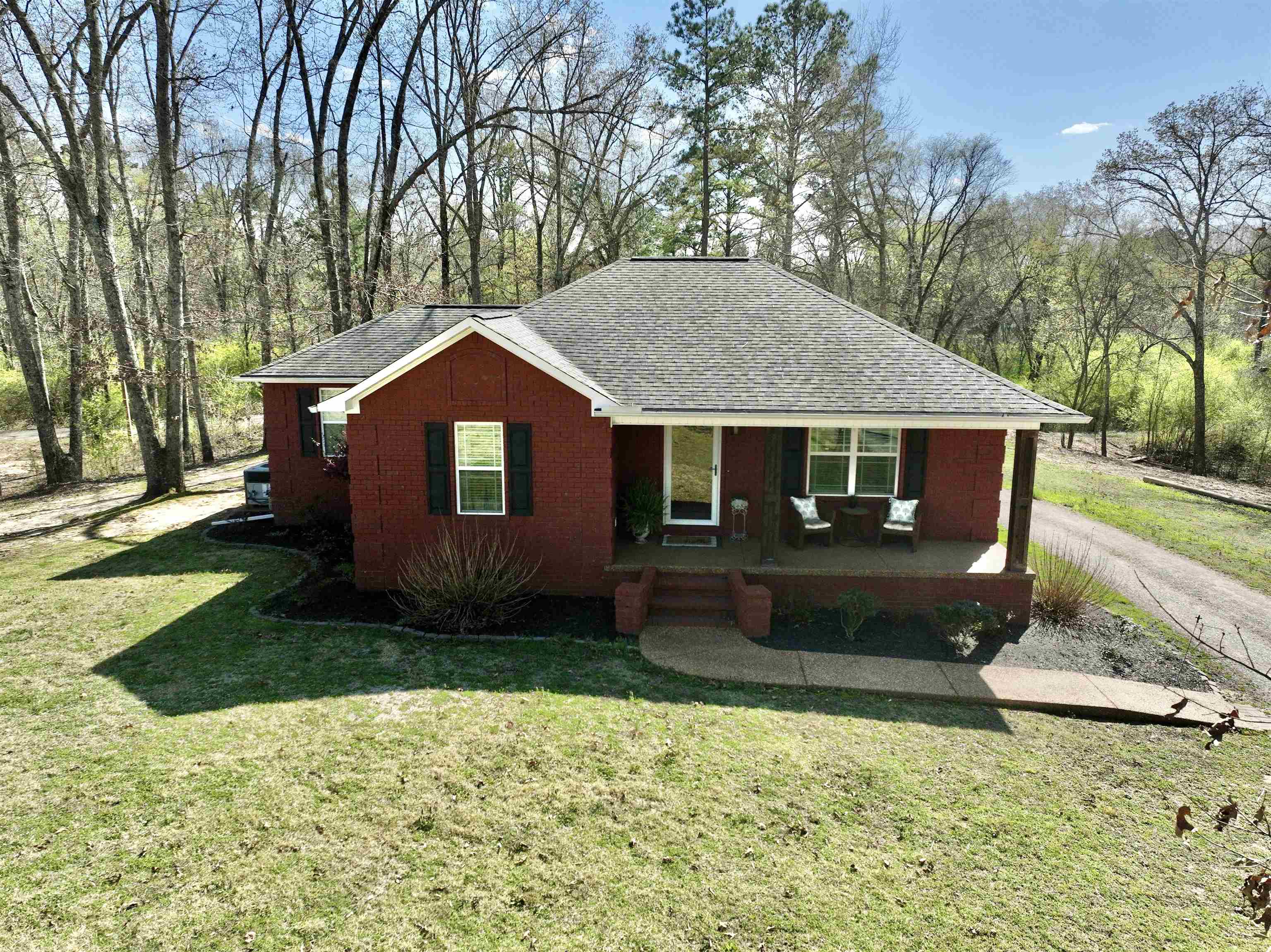 40 Foxtrot Road Adamsville, TN 38310 - Photo 12 of 39 Single story home featuring a front lawn, covered porch, and roof with shingles
