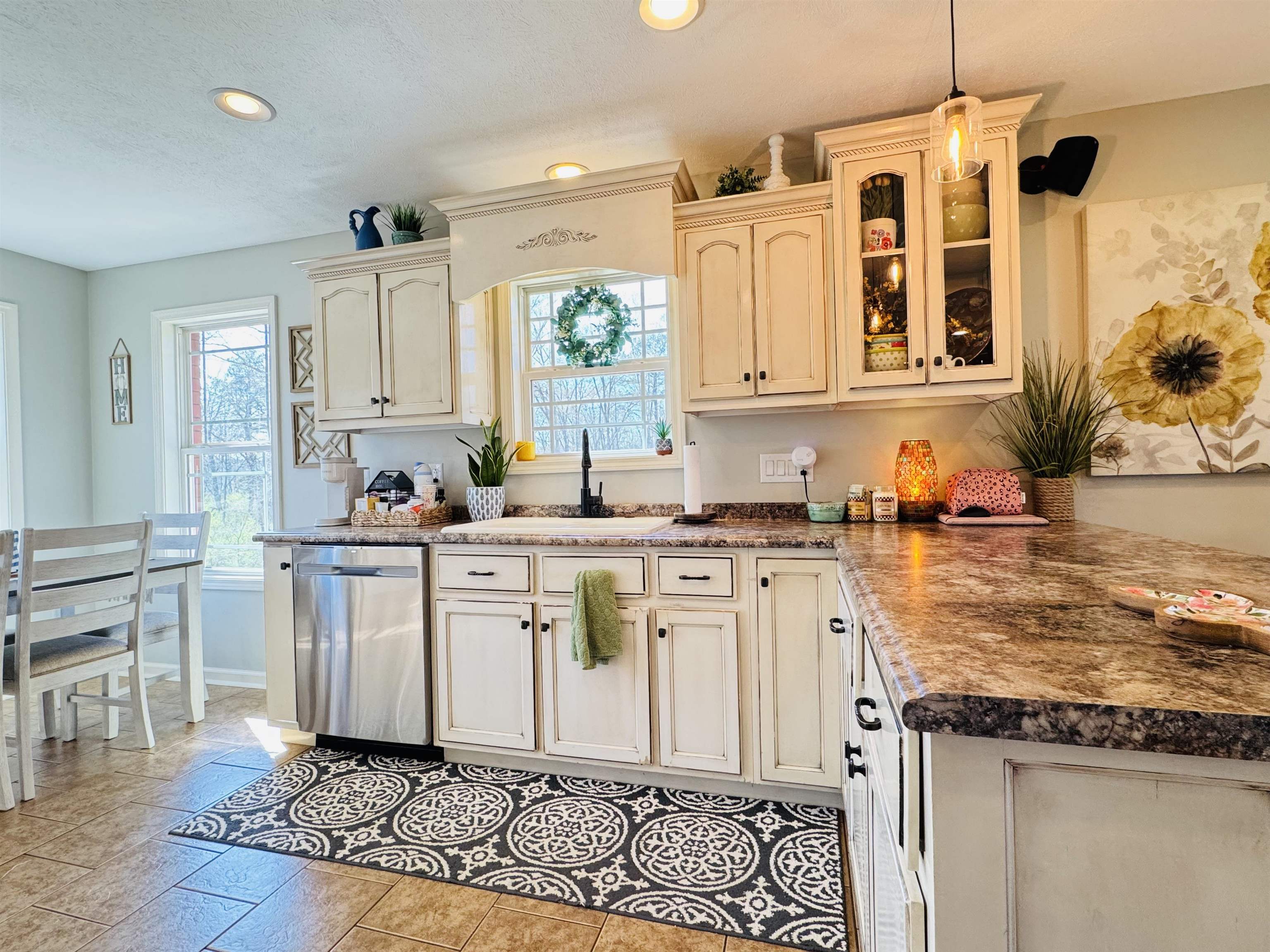 40 Foxtrot Road Adamsville, TN 38310 - Photo 16 of 39 Kitchen featuring a peninsula, dishwasher, glass insert cabinets, a sink, and decorative light fixtures