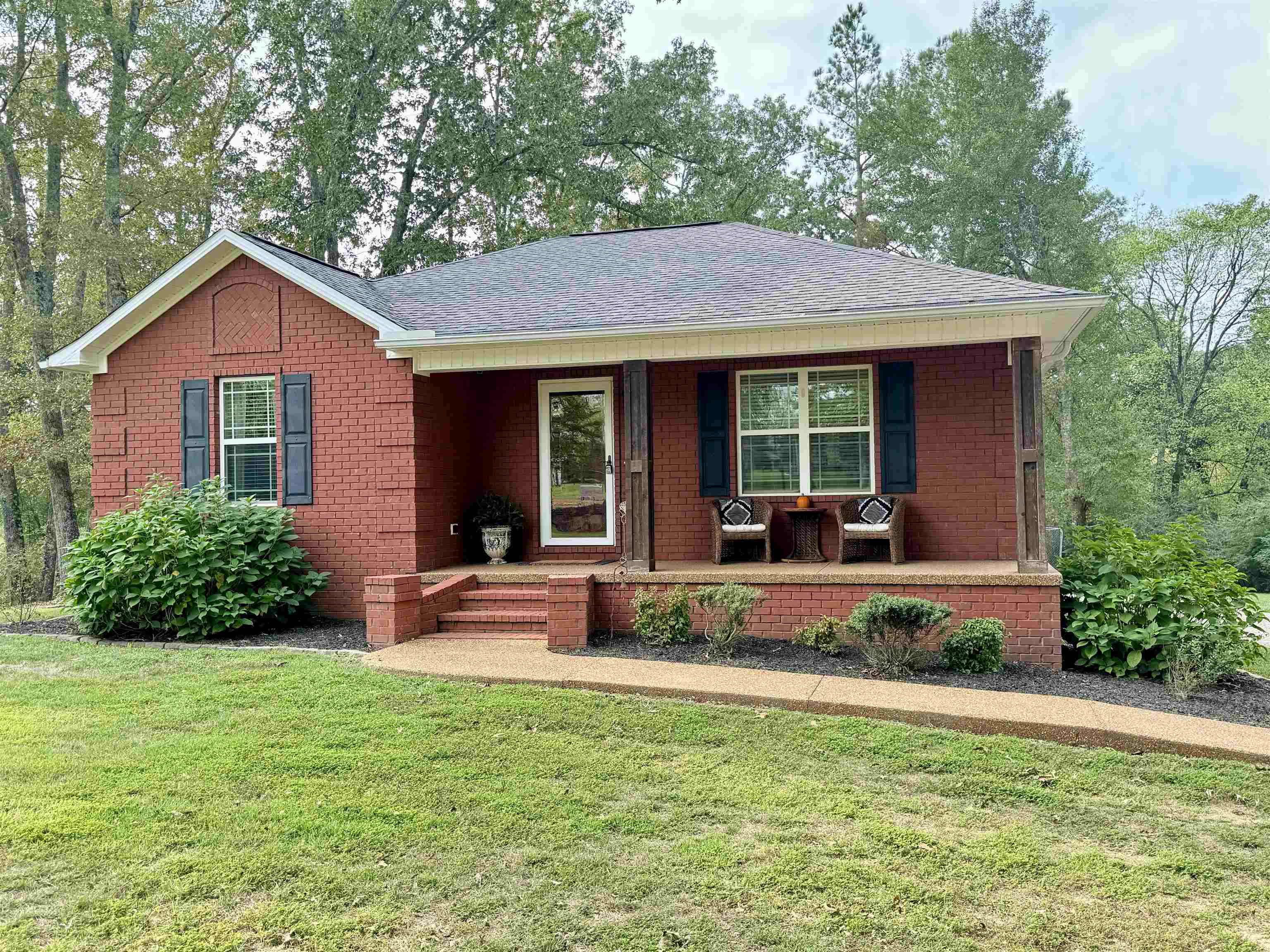 40 Foxtrot Road Adamsville, TN 38310 - Photo 3 of 39 Ranch-style house with a front yard, covered porch, brick siding, and roof with shingles