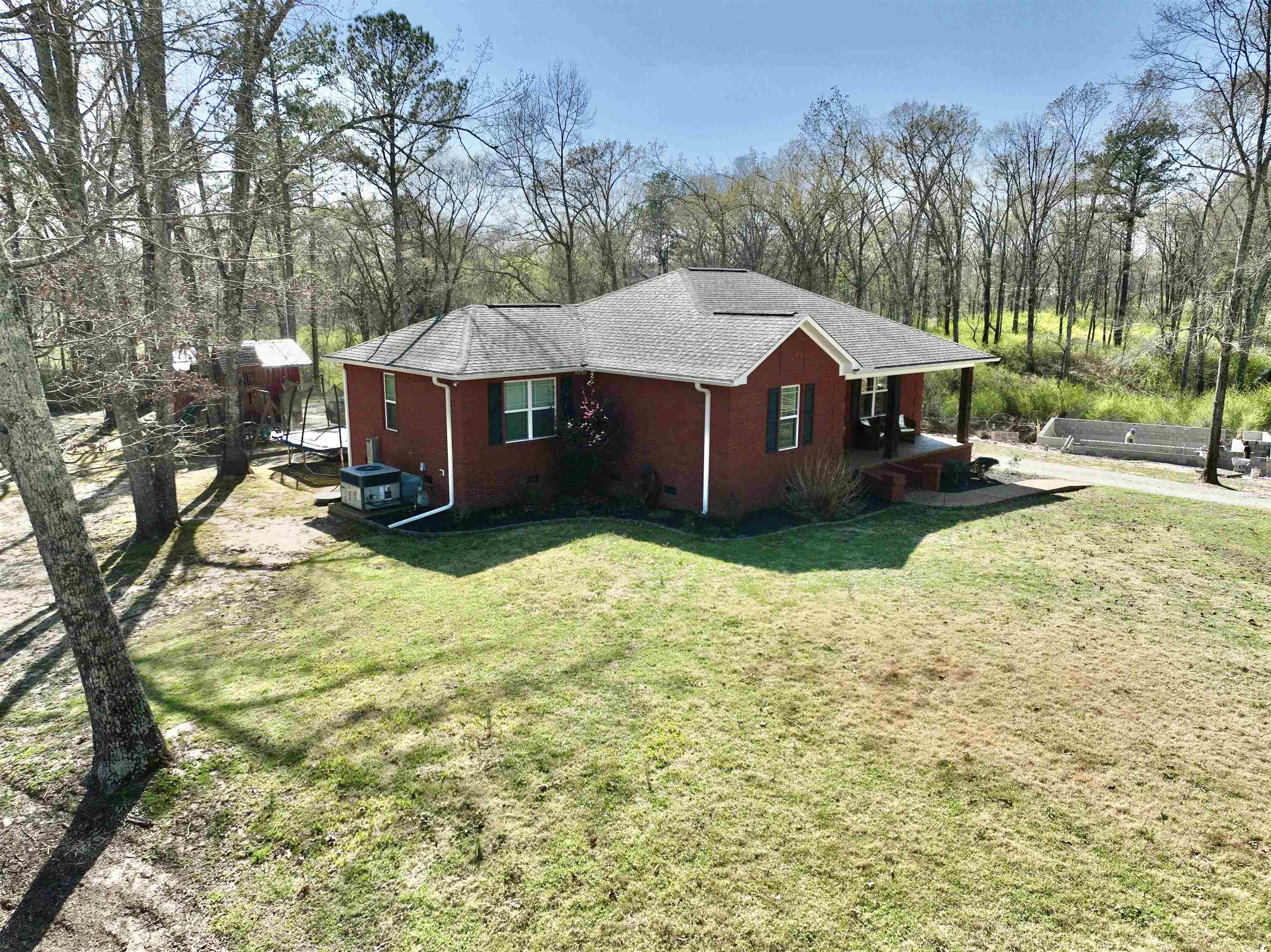 40 Foxtrot Road Adamsville, TN 38310 - Photo 29 of 39 View of side of home featuring roof with shingles and a yard
