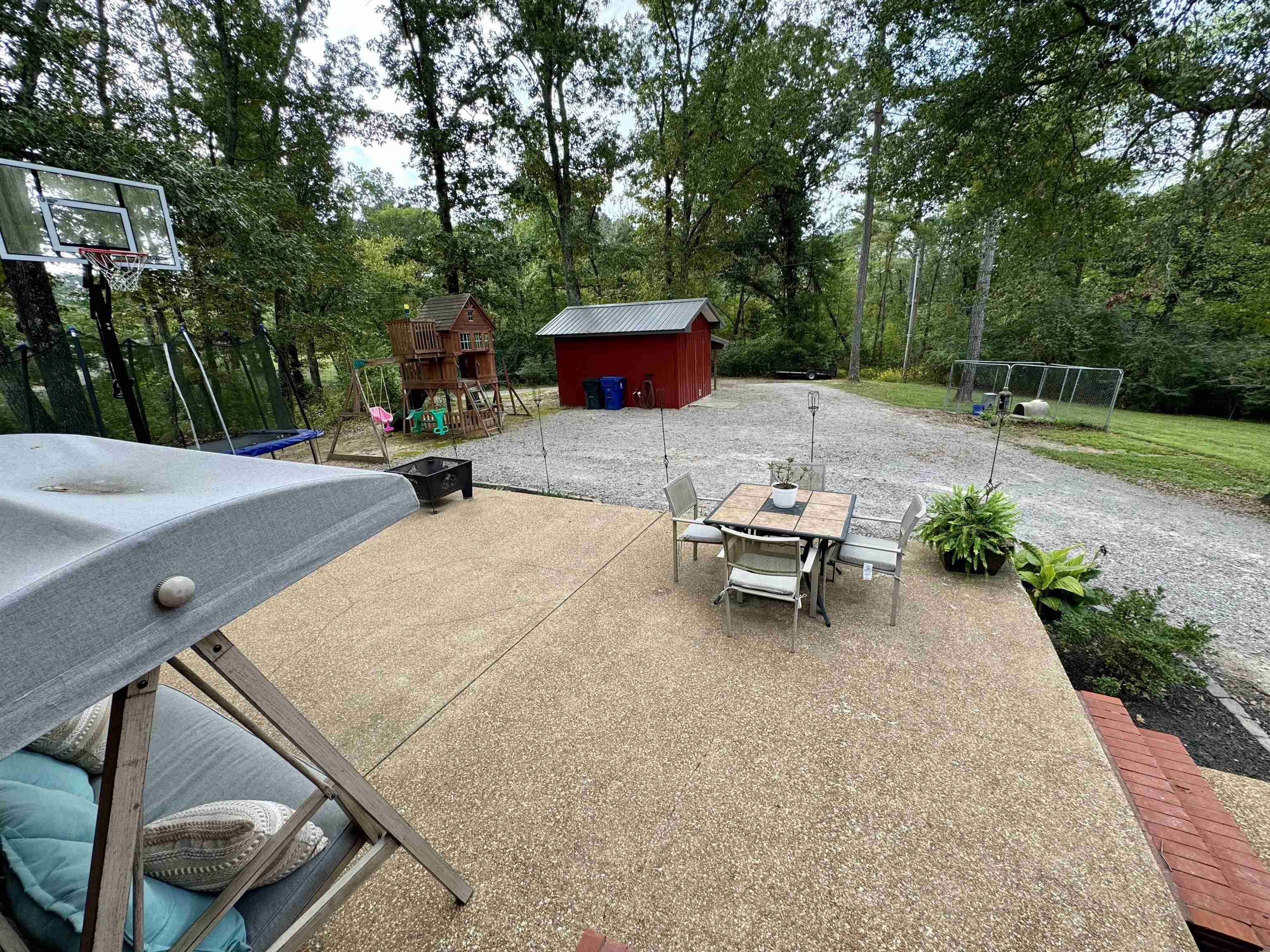 40 Foxtrot Road Adamsville, TN 38310 - Photo 32 of 39 View of patio / terrace featuring an outdoor structure, a shed, outdoor dining area, a playground, and area for grilling