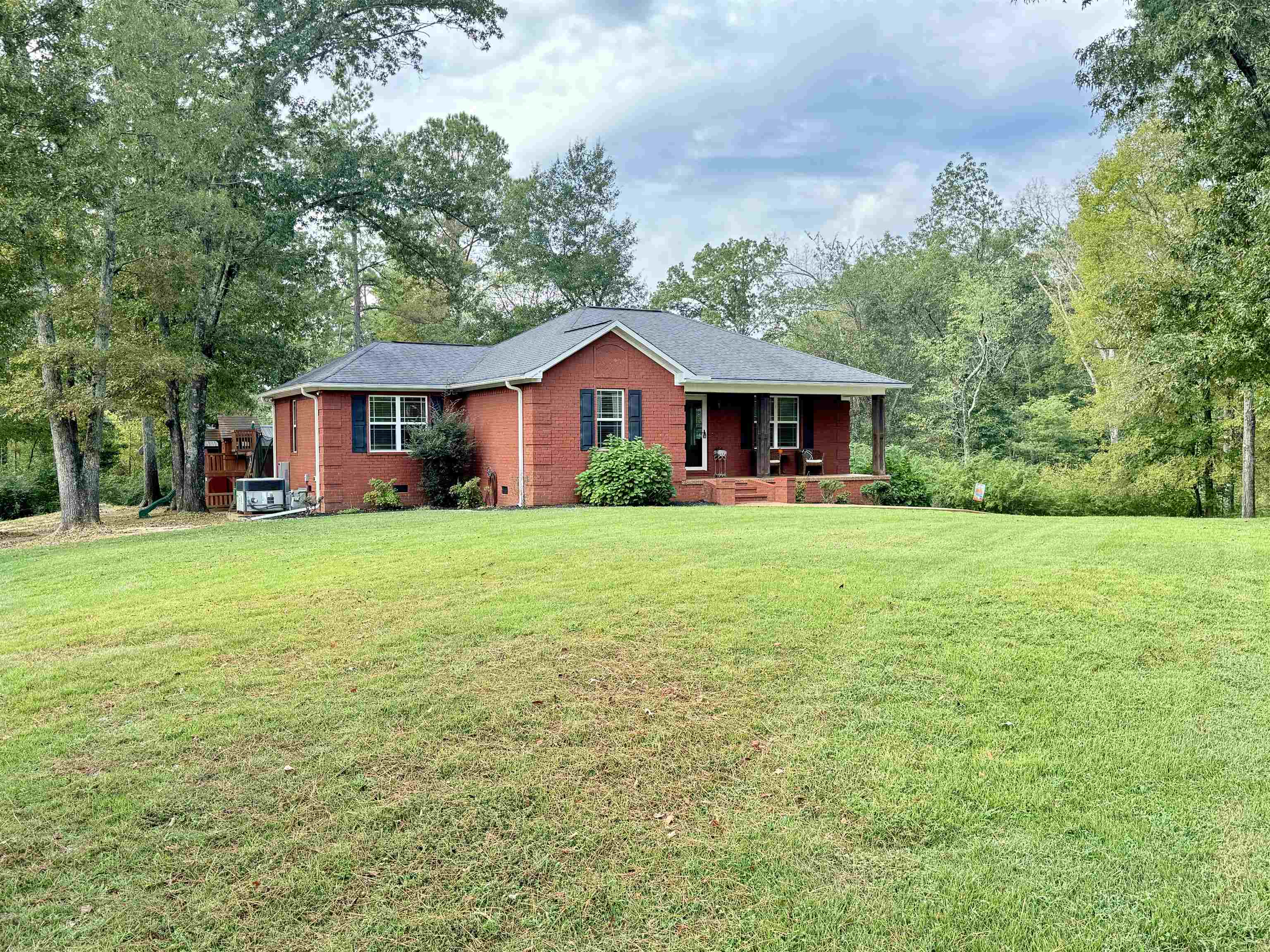 40 Foxtrot Road Adamsville, TN 38310 - Photo 6 of 39 Ranch-style house with brick siding, central AC, covered porch, and a front yard