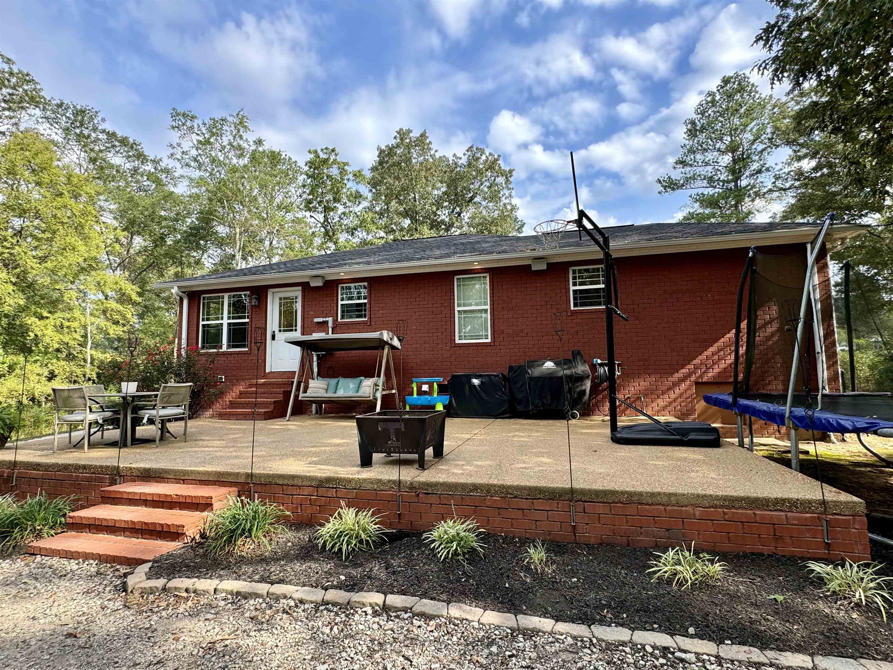 40 Foxtrot Road Adamsville, TN 38310 - Photo 8 of 39 Back of house with entry steps, a patio, brick siding, and a trampoline
