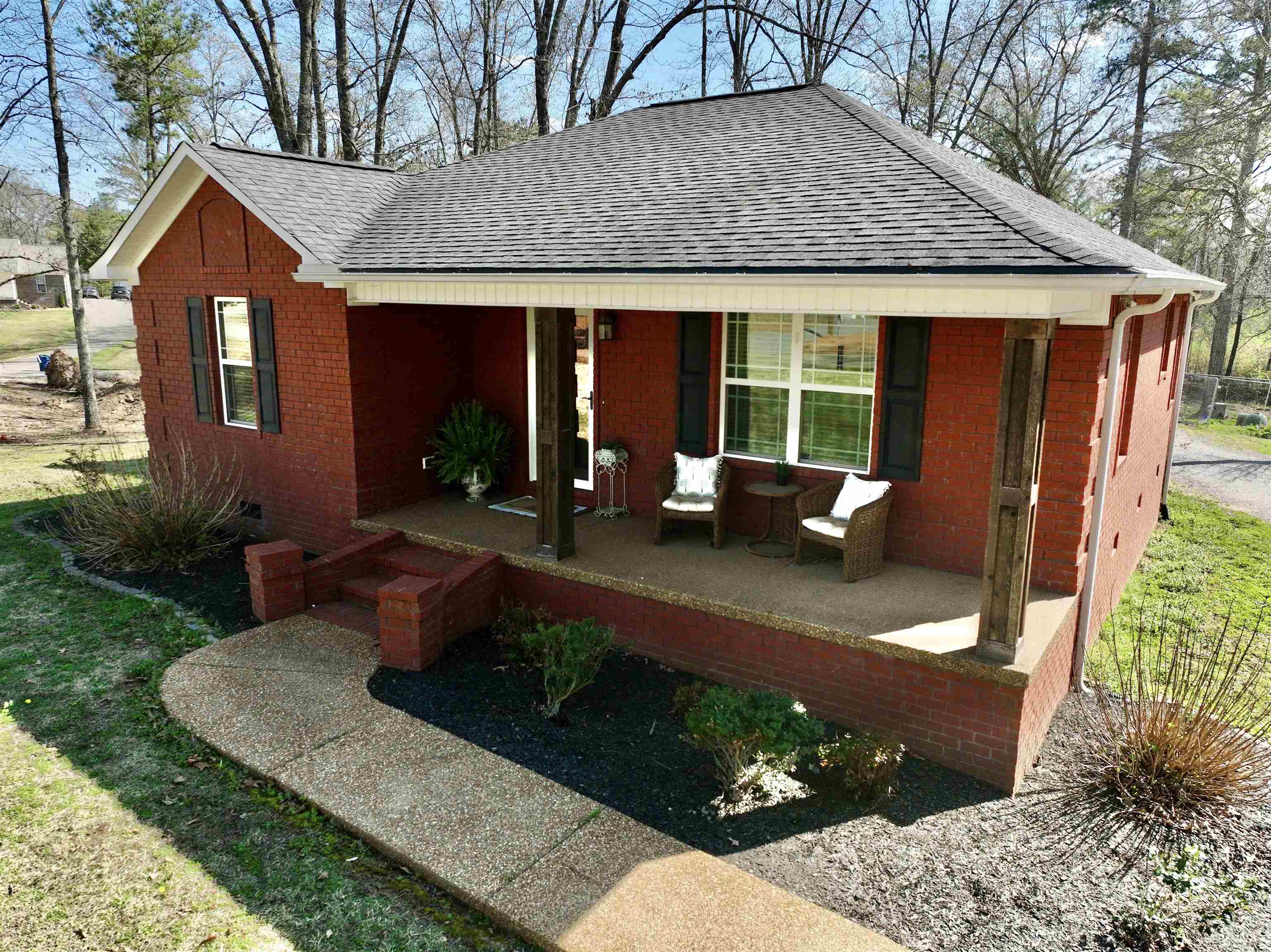 40 Foxtrot Road Adamsville, TN 38310 - Photo 10 of 39 Exterior space with covered porch, brick siding, and a shingled roof