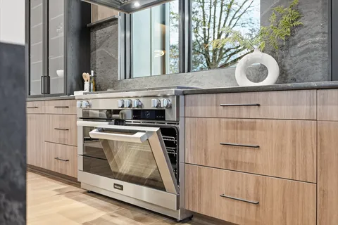 a bathroom with a granite countertop sink a toilet and a mirror