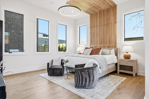 a view of an empty room with a window and chandelier